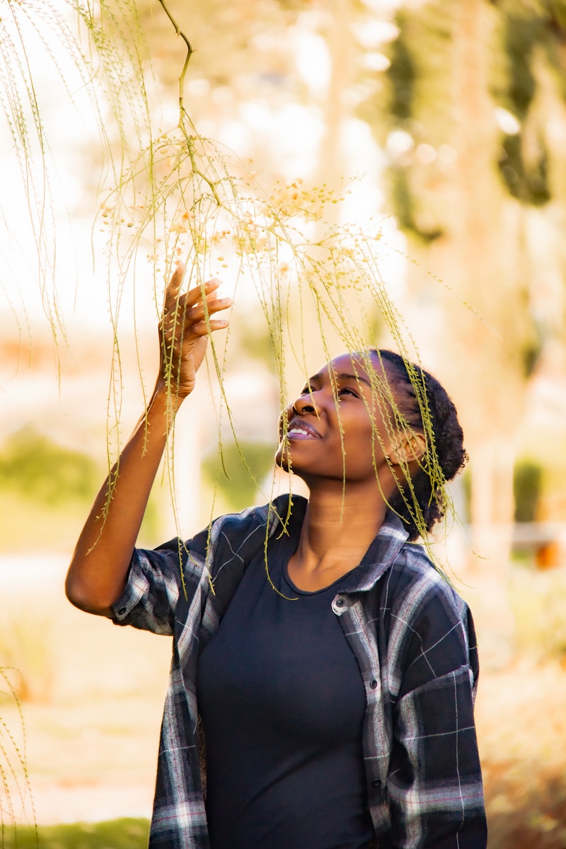 a woman holding a bunch of plants up to her face