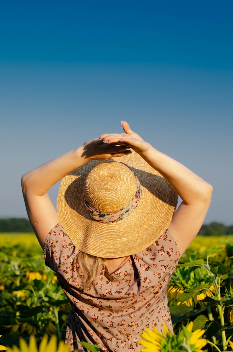 a woman standing in a field of sunflowers